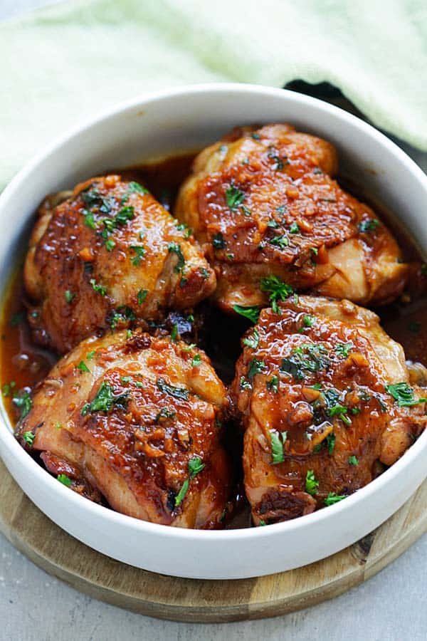 Honey Garlic Chicken with brown sauce, served in a bowl. The chicken thighs were pressured cooked.