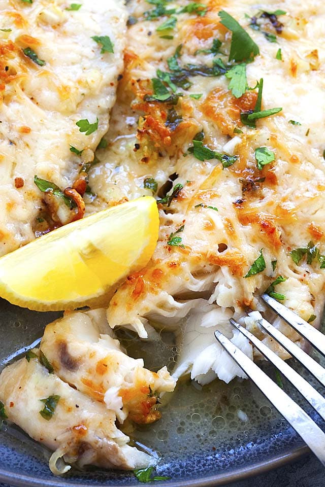 Baked tilapia recipe with baked tilapia, Parmesan cheese and lemon.