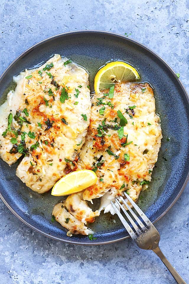 Baked lemon parmesan tilapia in a serving plate.