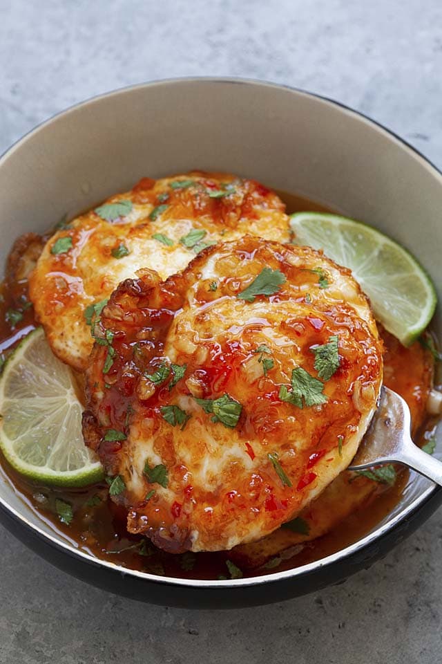 Fried eggs with Thai sweet chili sauce in a bowl.