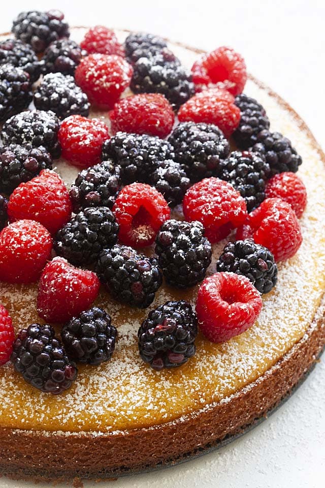Close up picture of French yogurt cake, with raspberries and blueberries.