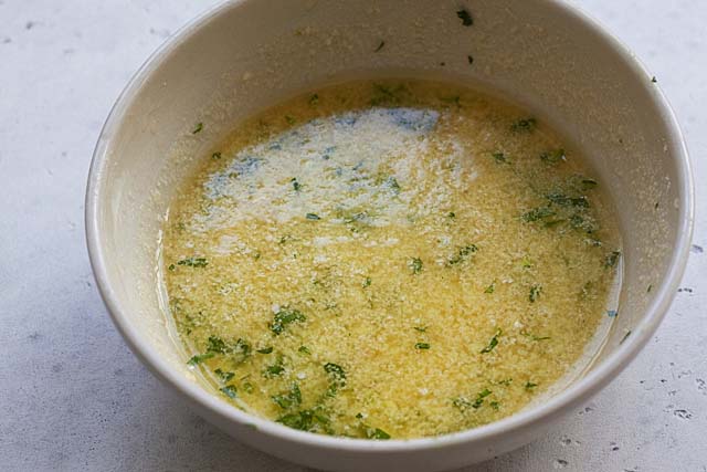 Garlic butter spread in a bowl ready to be brushed on garlic bread.