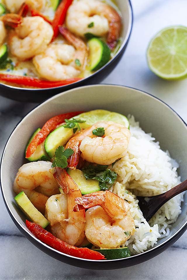 Shrimp curry with coconut milk, served with a bowl of rice.