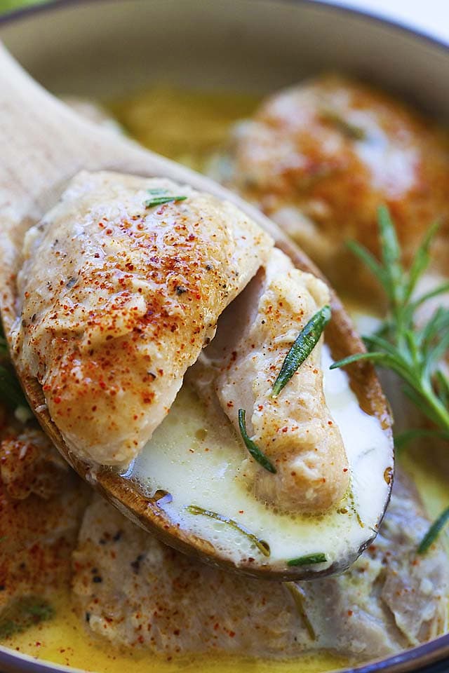 Close up picture of a tender piece of instant pot chicken thighs with creamy sauce.