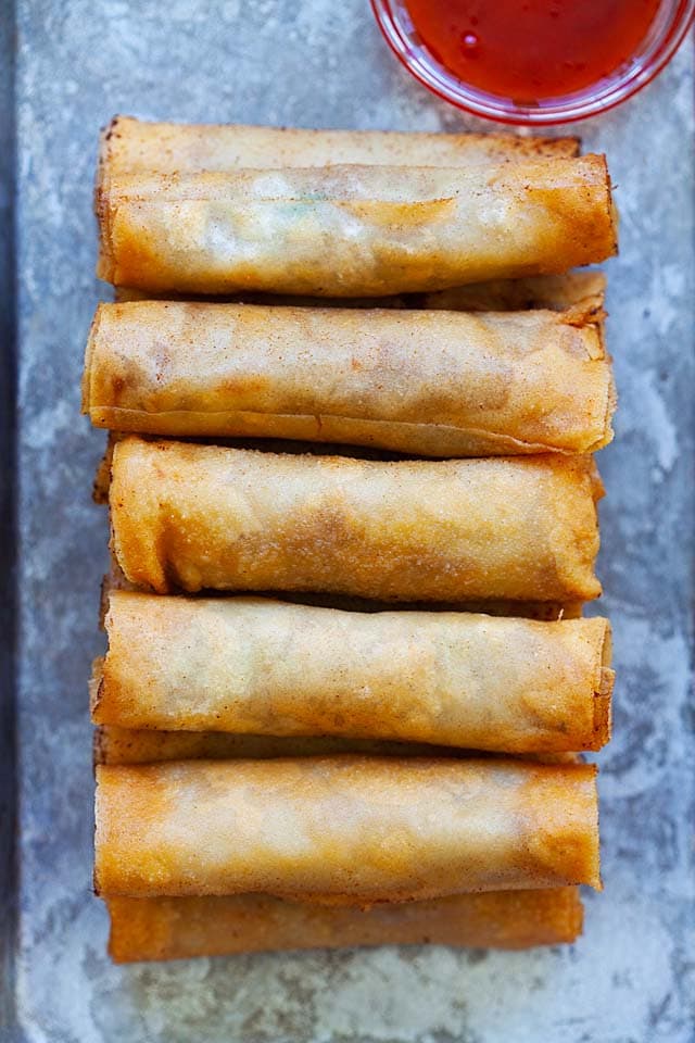 Top down picture of lumpiang Shanghai with lumpia sauce.