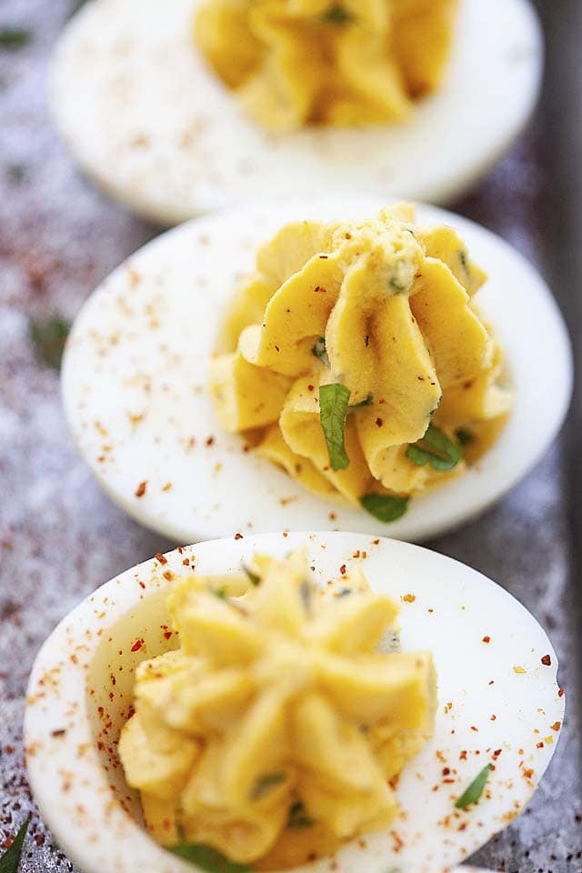 Close up image of deviled eggs with Sriracha.