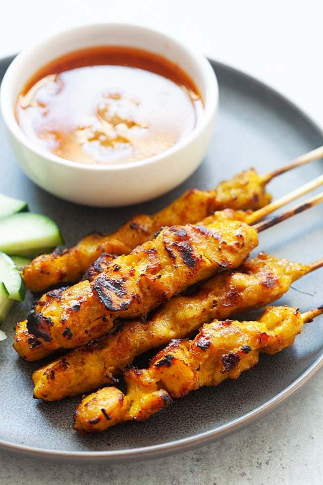 Authentic chicken satay skewers with satay sauce.