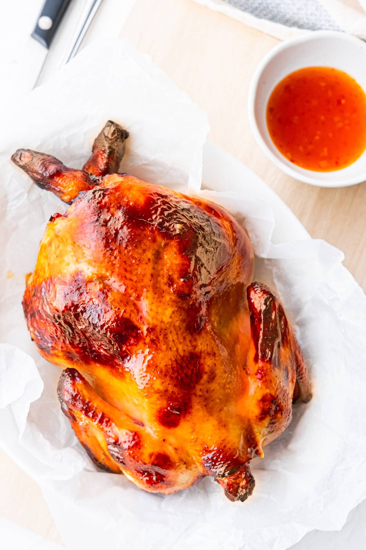 Chinese roast chicken with crispy skin on a parchment paper. 