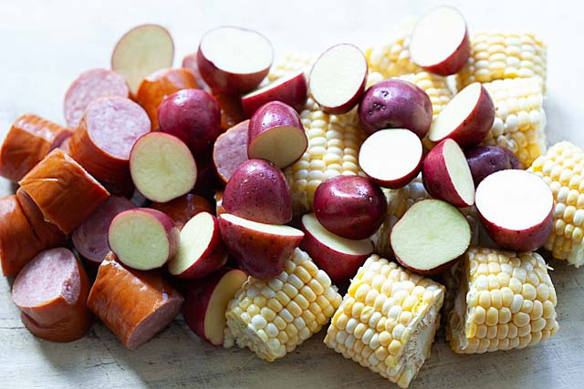 Ingredients for the best crawfish boil recipe: live crawfish (crayfish), corn, smoked sausage, and red potatoes.