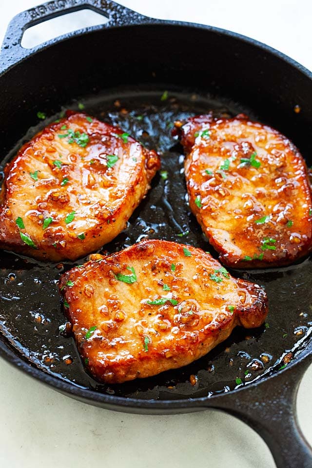 Boneless pork chops in a skillet.