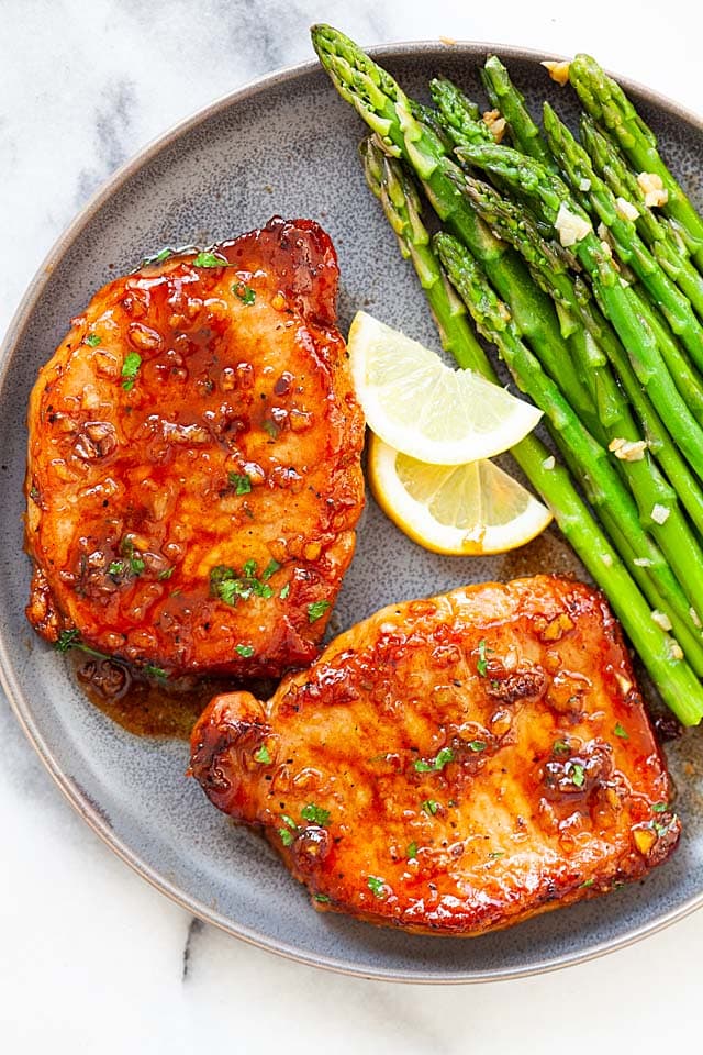 Honey garlic boneless pork chops served on a plate.