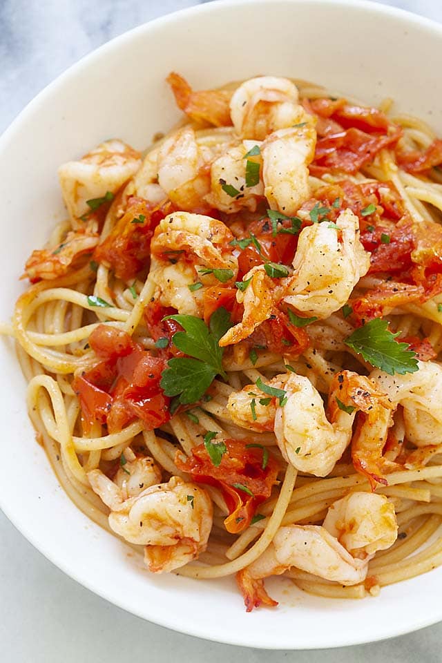 One of the best shrimp and pasta recipes with shrimp, spaghetti, tomatoes, garlic and chopped parsley.