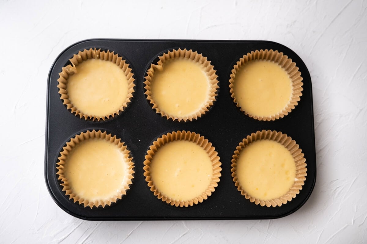 Mini egg cake batter in cupcake molds, ready to bake. 