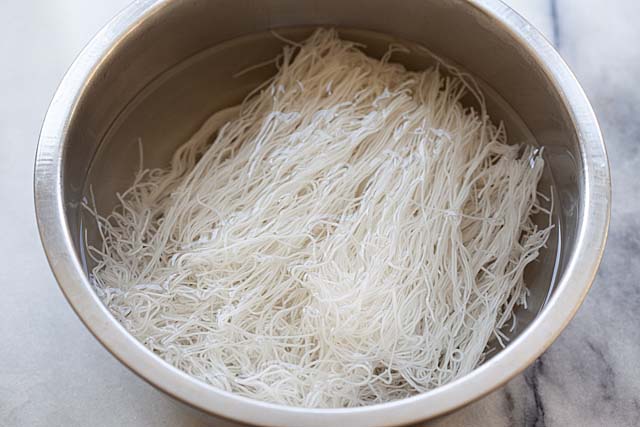 Soaking rice sticks or vermicelli in water before cooking.
