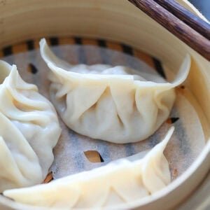 Steamed dumplings in a bamboo steamer.