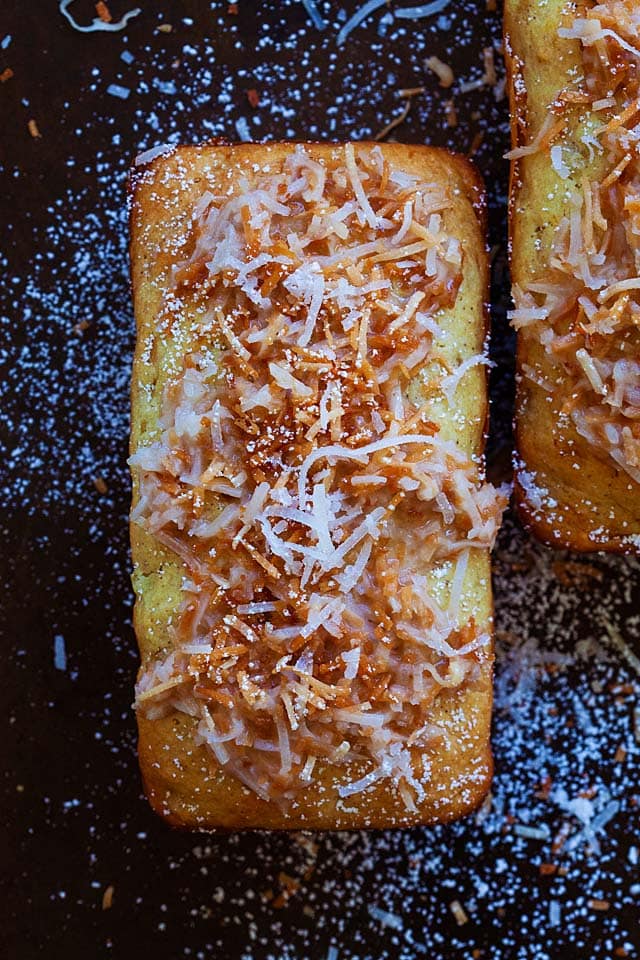 Loaf of pineapple coconut quick bread, topped with toasted coconut.