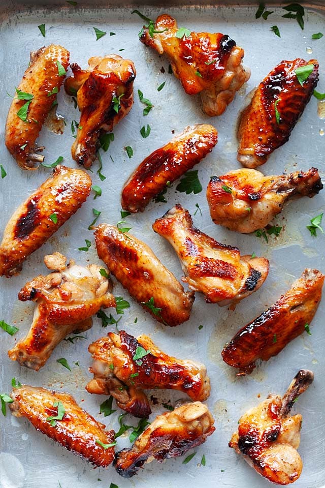 Top down picture of oven baked chicken wings on a baking sheet, ready to serve.