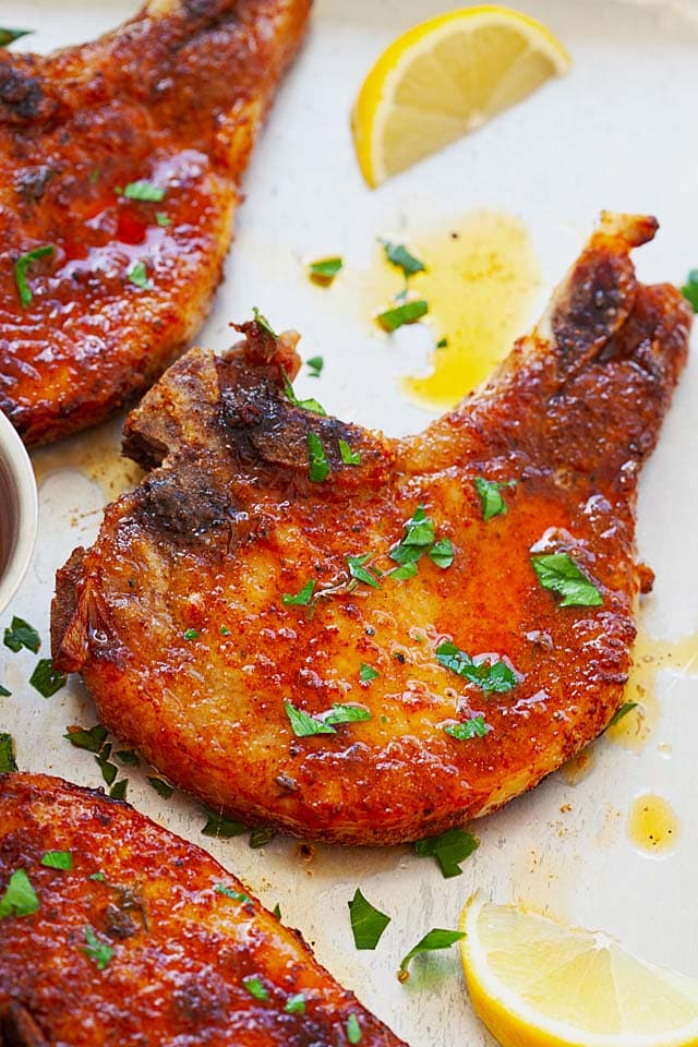 Baked pork chops on a serving tray.