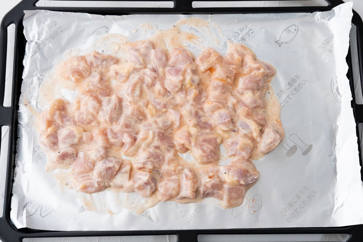 Spread the marinated chicken on a baking pan lined with aluminum foil. 