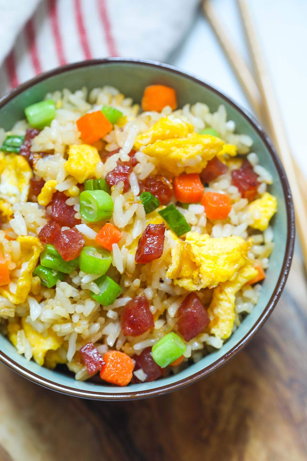 Authentic Chinese fried rice restaurant style served in a Chinese bowl with a pair of chopsticks.