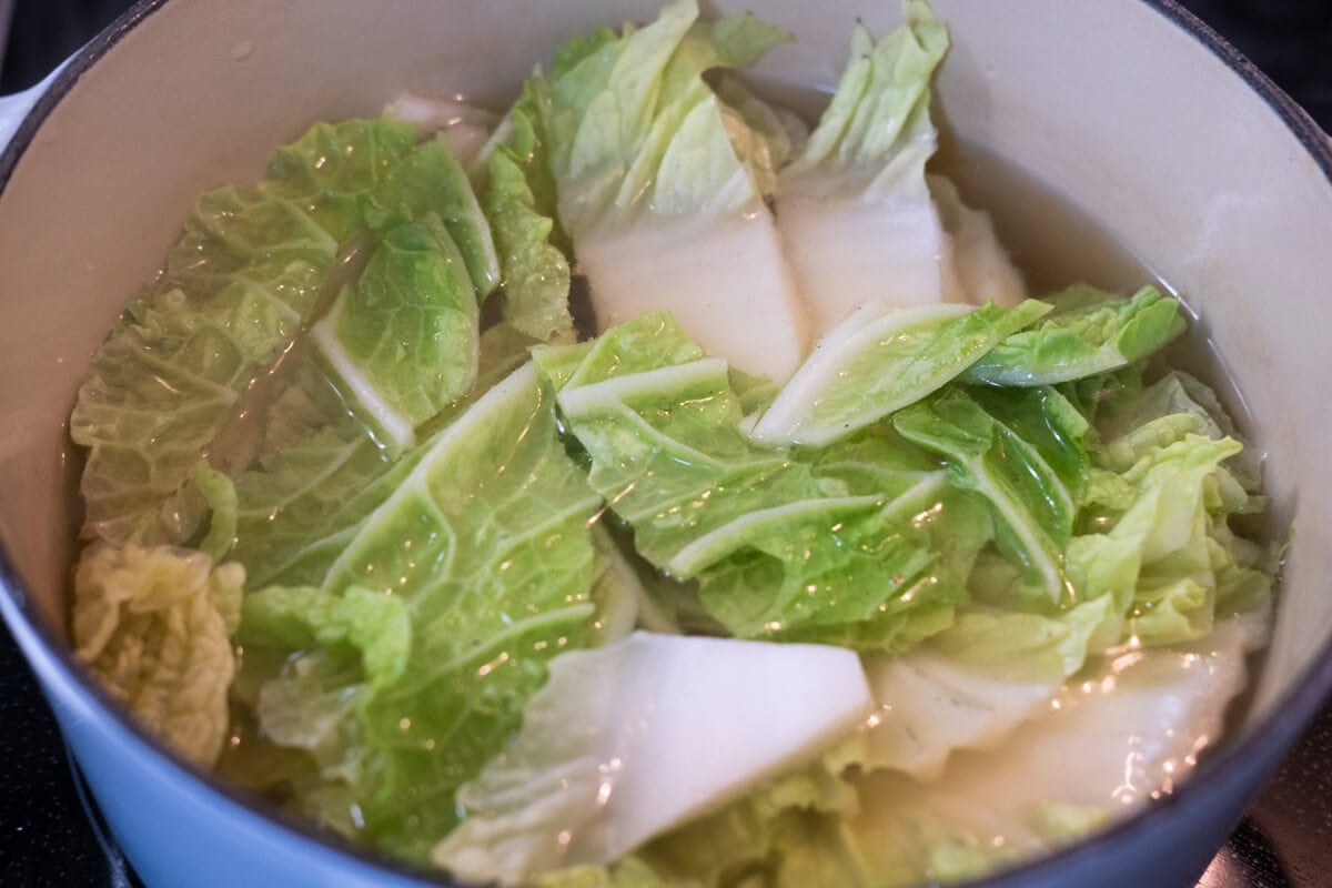 Napa cabbage in a pot of Chinese hot pot broth. 