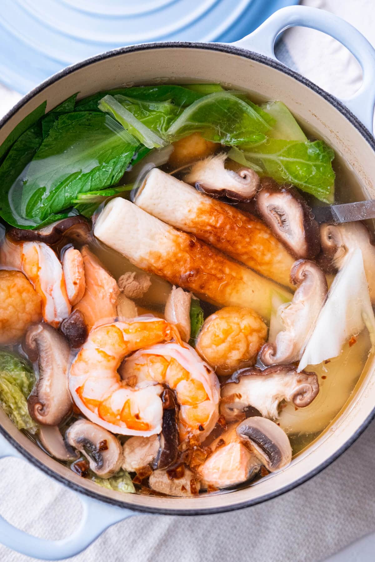 Hearty Chinese hot pot broth with chicken, seafood and vegetables. 