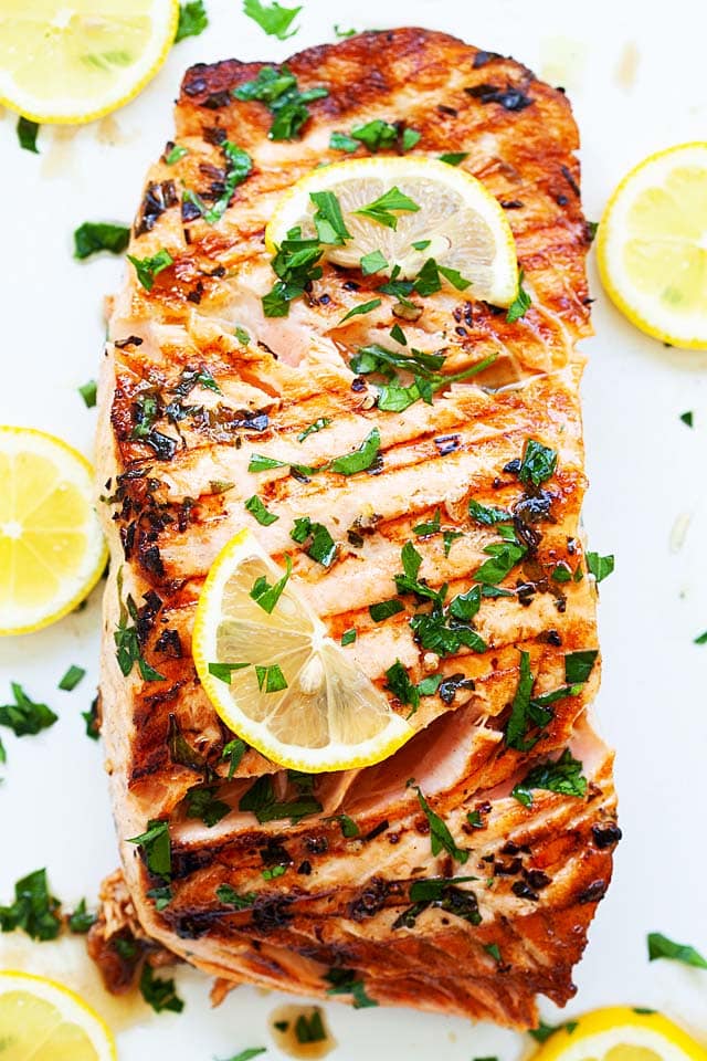Grilled salmon with lemon on a plate, ready to serve.