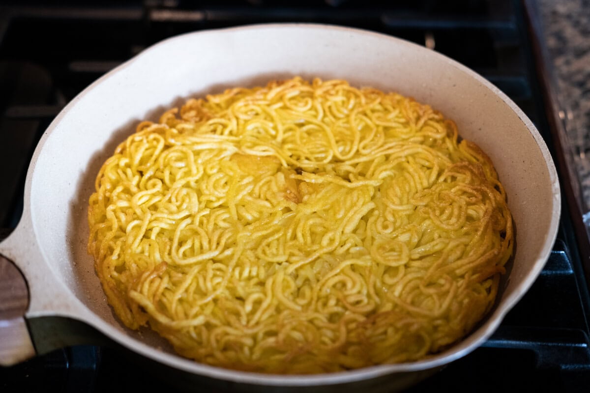 Crispy noodles in a skillet.