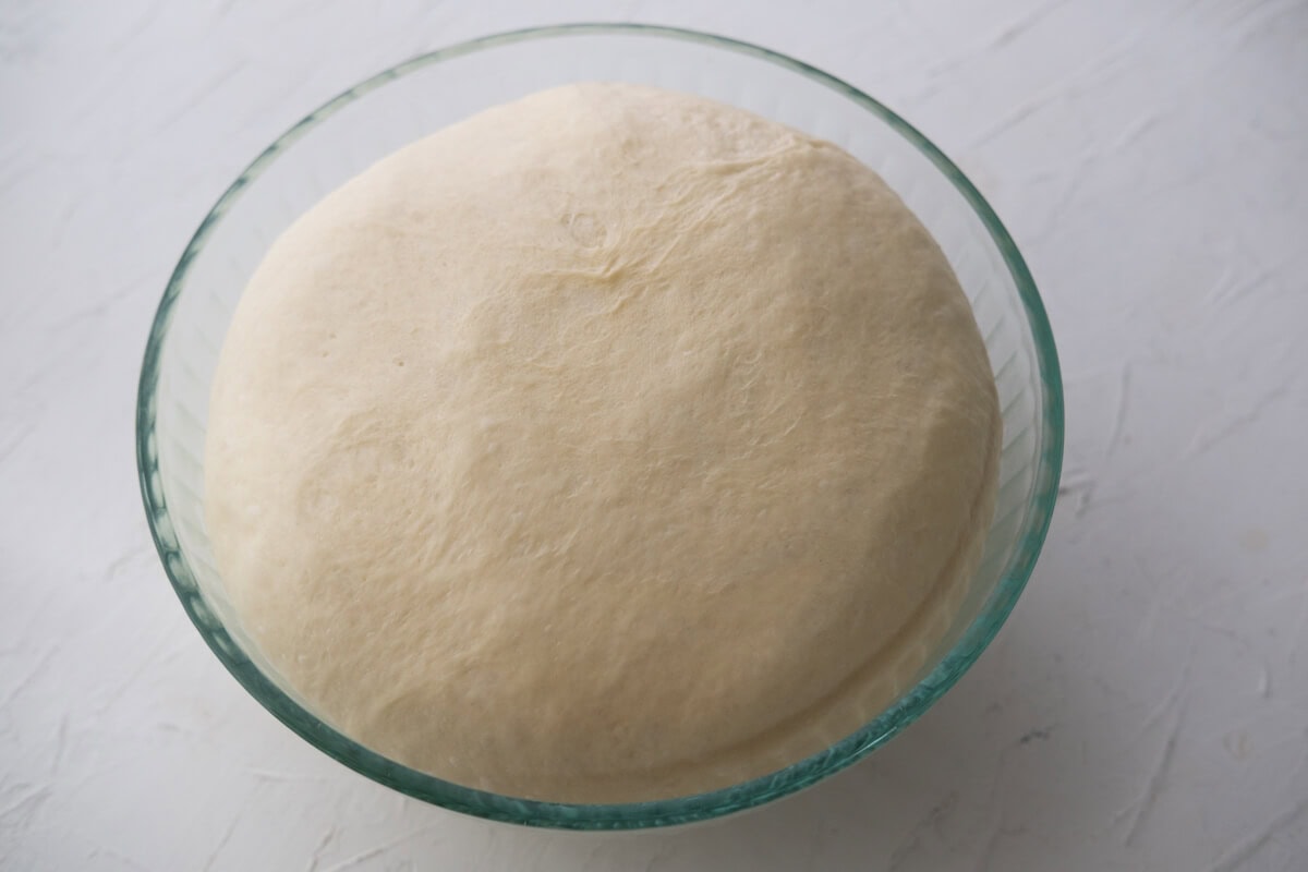 Let the homemade sausage roll dough rise in a large bowl. 