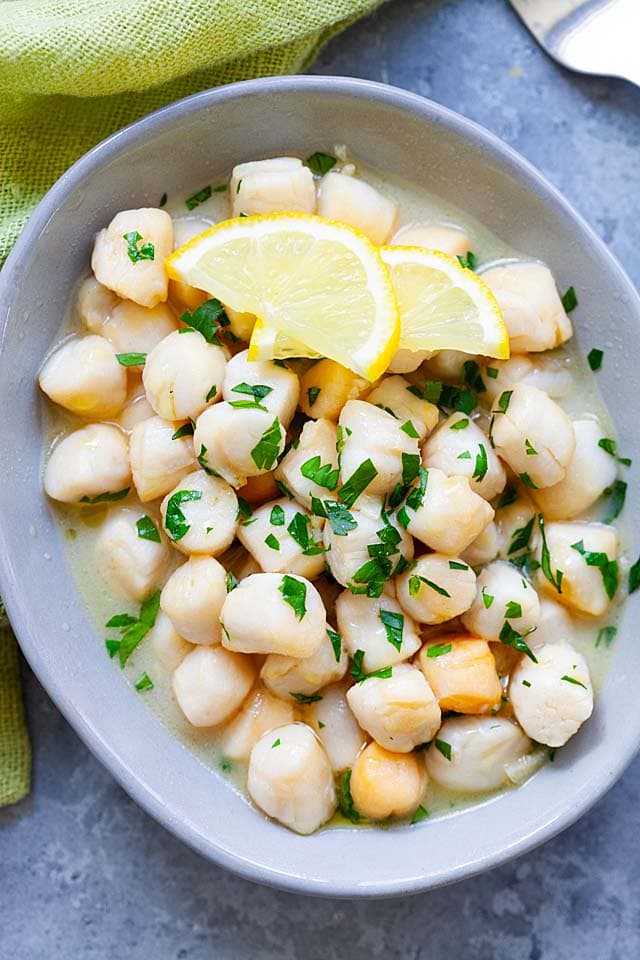 Sauteed scallops with lemon butter in a plate, ready to be served.