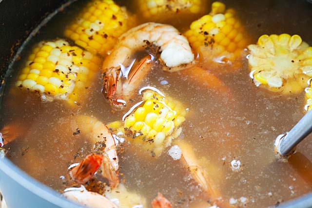 Shrimp boil in a pot of boiling water with shrimp boil seasonings.
