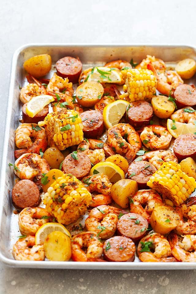 Shrimp and sausage boil on a baking sheet, ready to eat.
