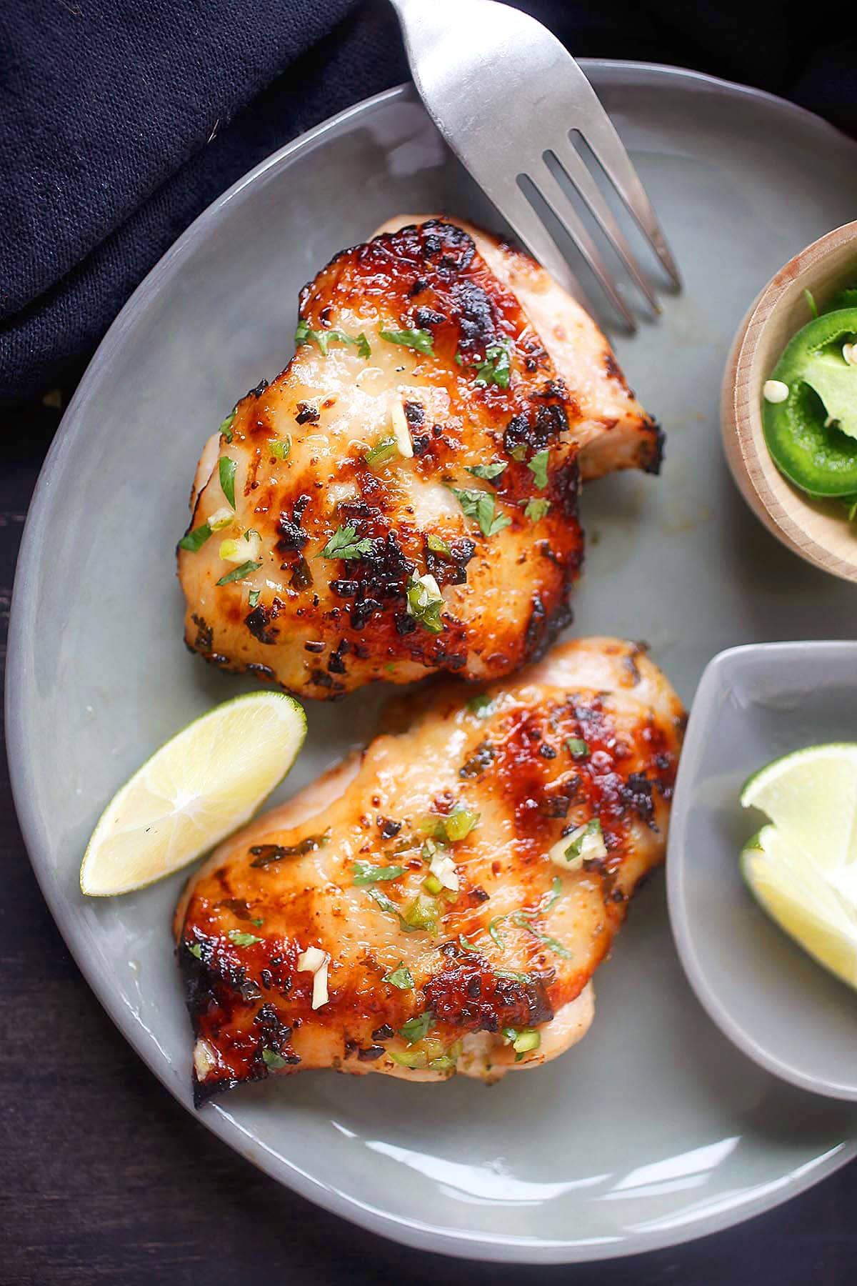 Lime chipotle chicken thighs on a plate.