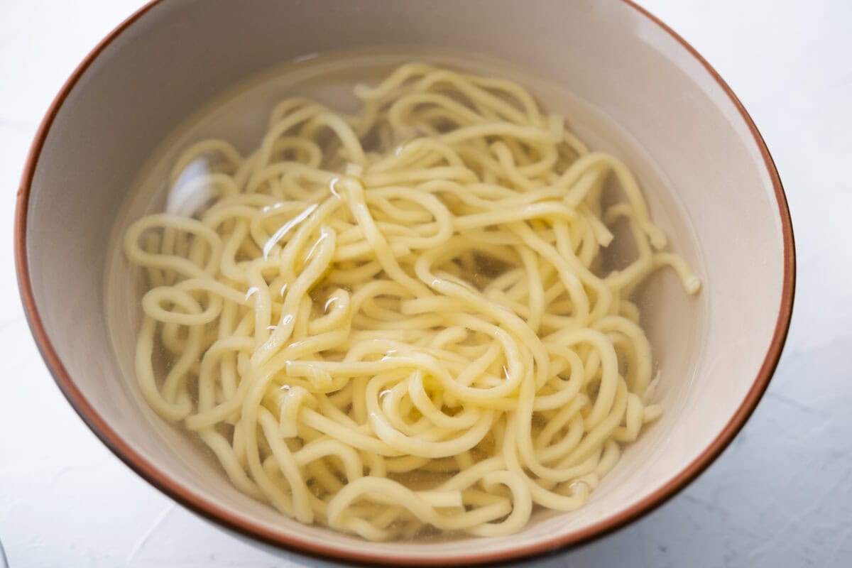 Soak the cooked noodles in cold water. 