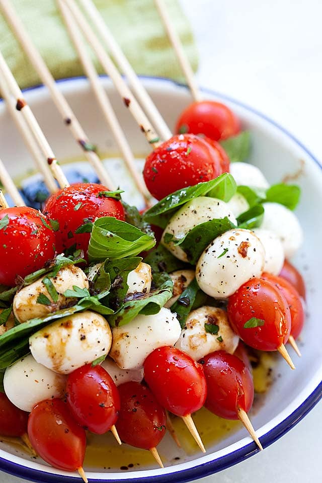 Close up picture of Caprese skewers with cherry tomatoes, mozzarella cheese and Italian basil.