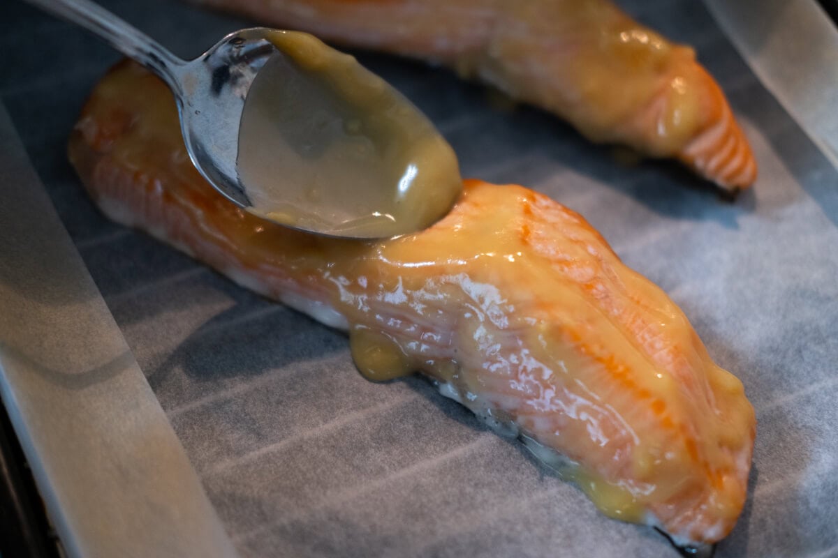 Spread the miso glaze on the salmon fillet using a spoon. 