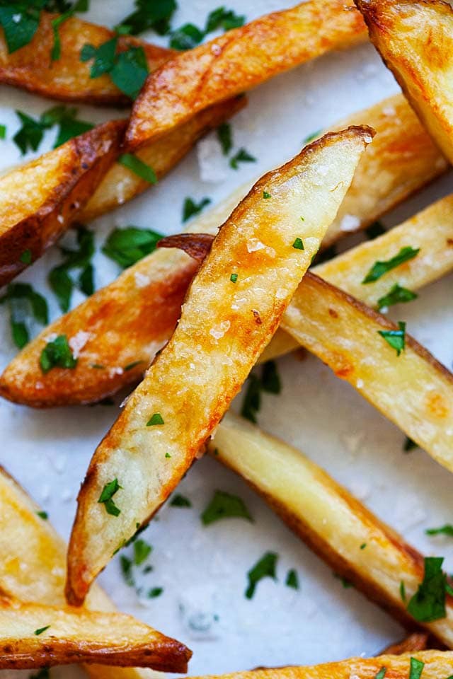 Homemade baked French fries with salt and vinegar seasoning.