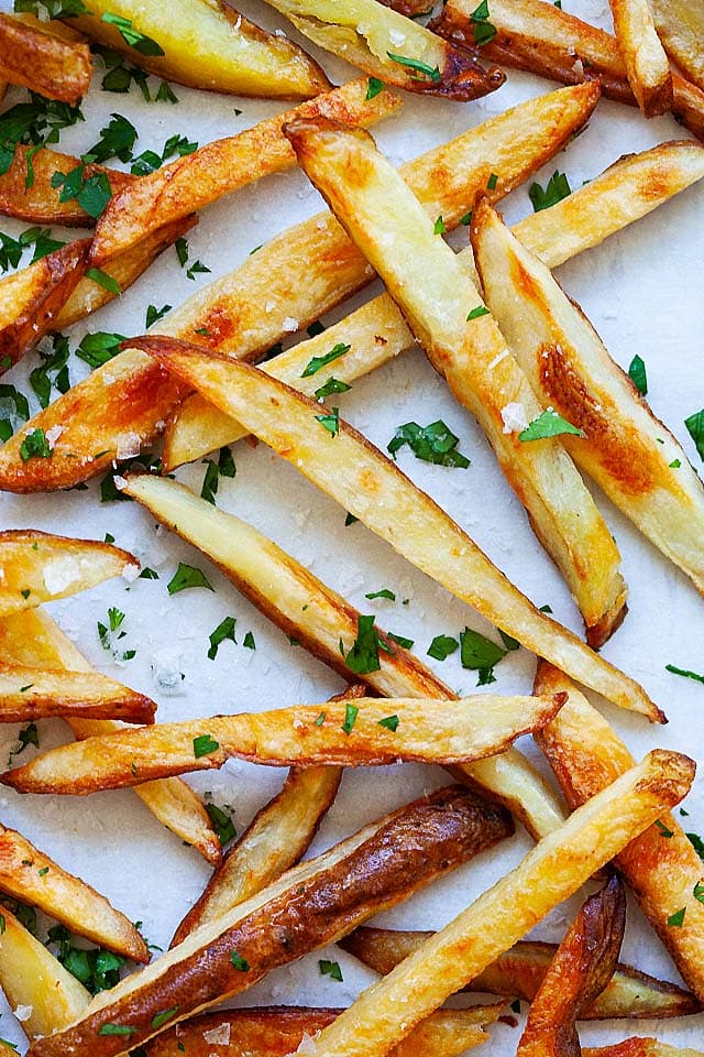 Baked French fries on a baking sheet, ready to serve.