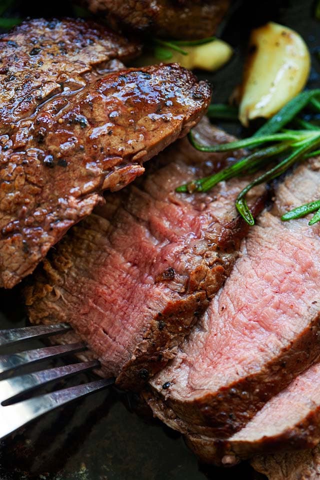 Filet mignon steak, pan seared on cast iron skillet.