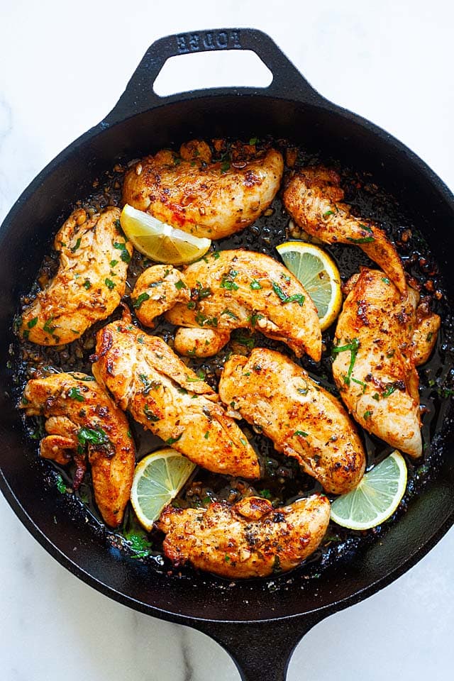 Chicken tenders on a skillet.