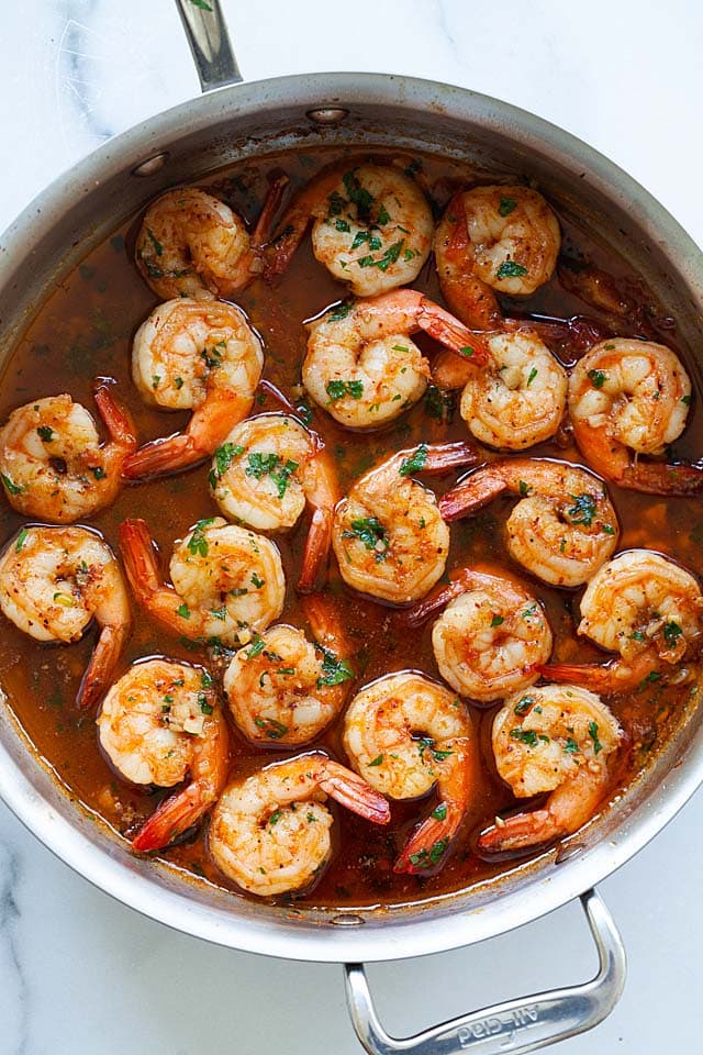 Shrimp and beer cooked in a skillet.