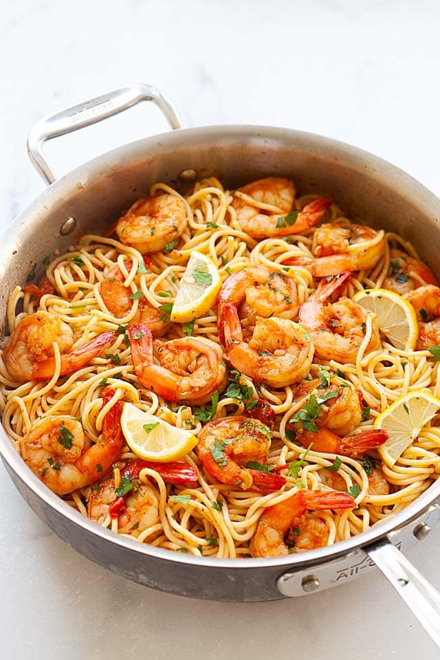 Shrimp and pasta cooked in a skillet.