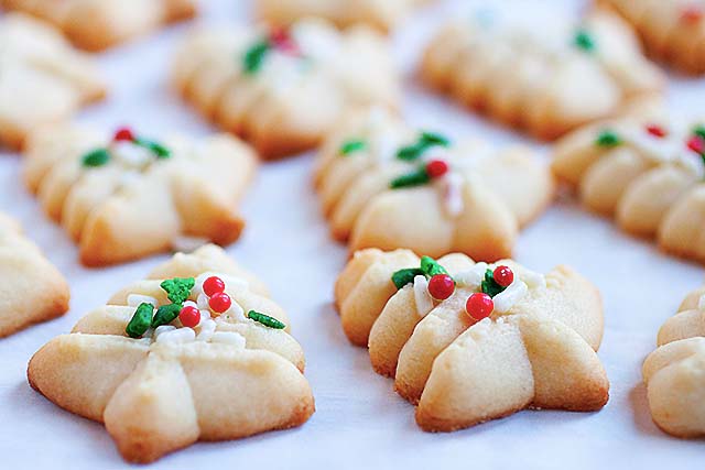 Spritz cookie recipe with Christmas tree shape and sprinkles.