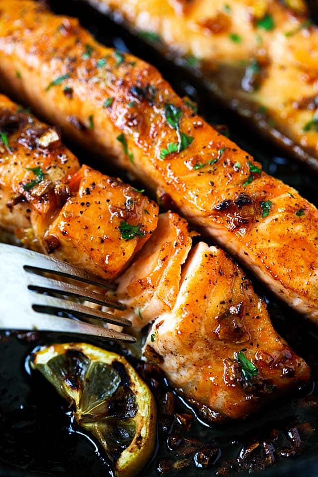 A fork poking through the honey garlic salmon.