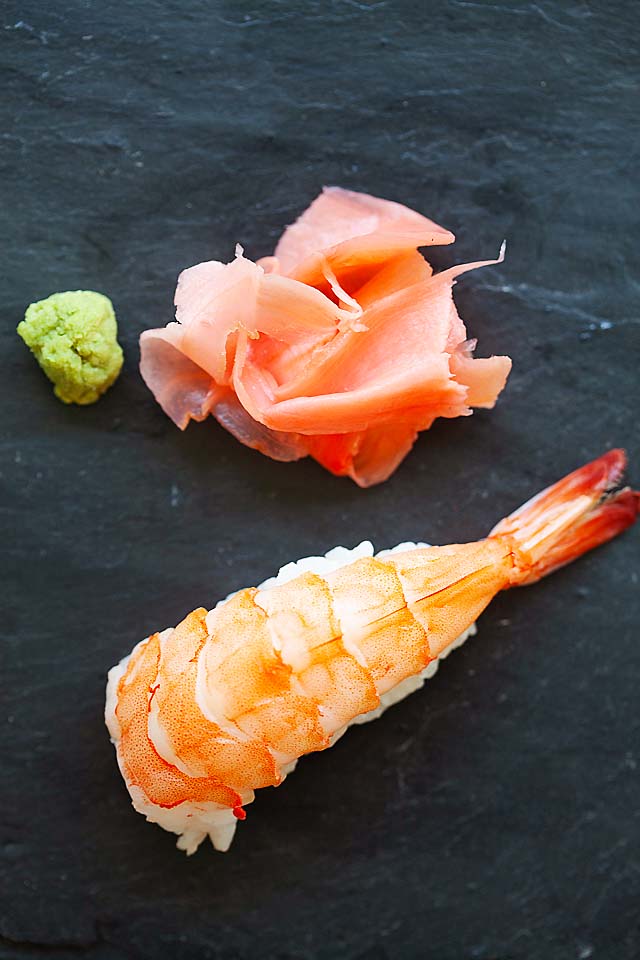 Nigiri sushi with soy sauce, gari (Japanese pickled ginger) and wasabi.