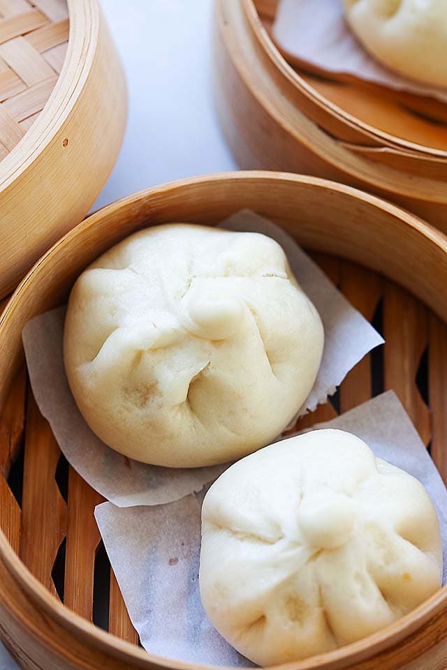 Char siu bao in a bamboo steamer. 