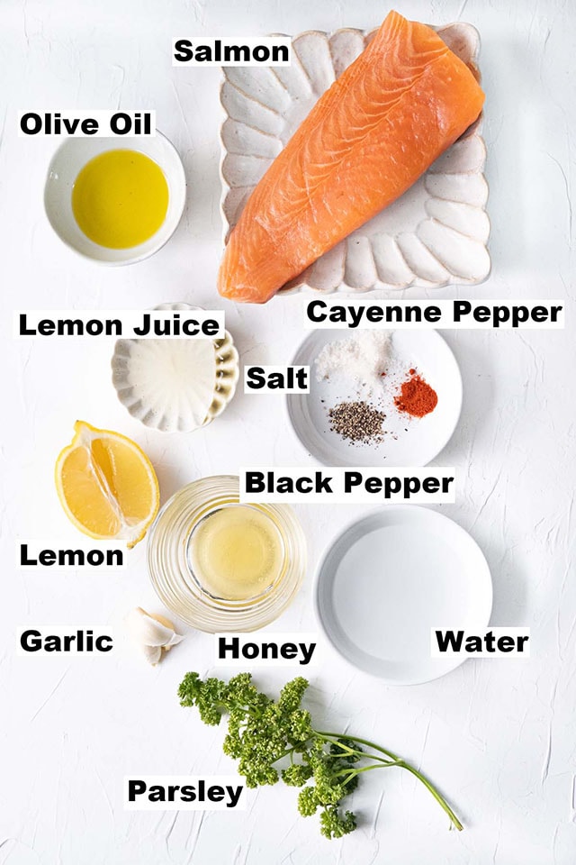 Ingredients needed for honey garlic salmon such as salmon, garlic, lemon, cayenne pepper, and honey.