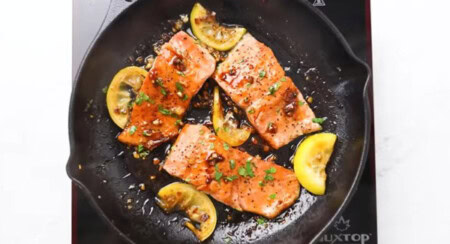 Cooking salmon with the honey garlic sauce.