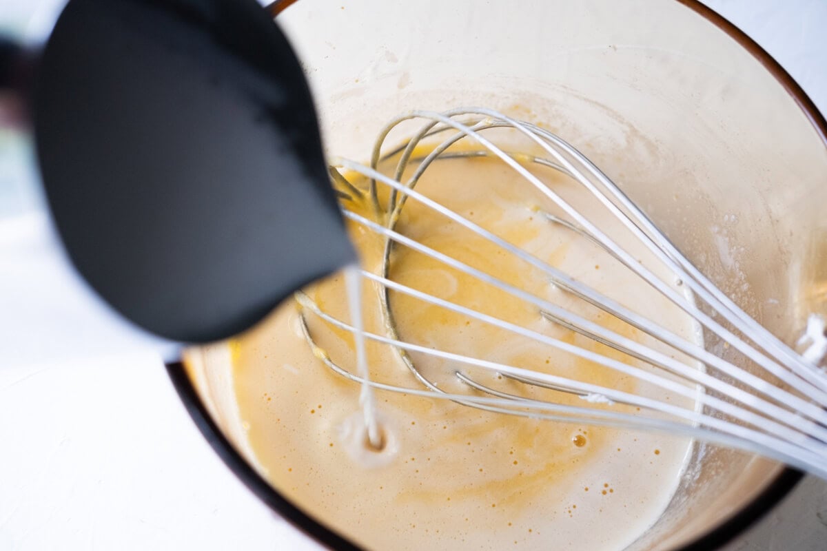 Pour the warm milk into the egg mixture. 