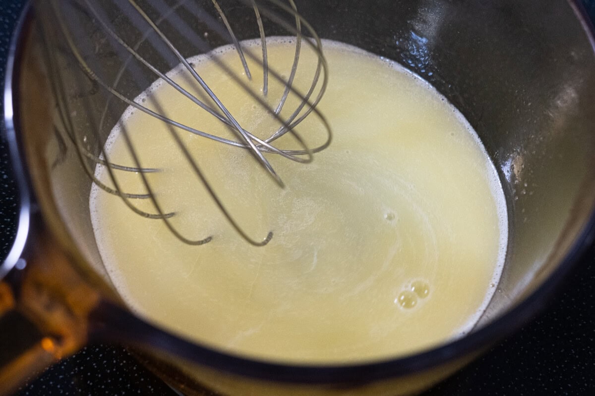 Heat butter, sugar, and water in a saucepan. 